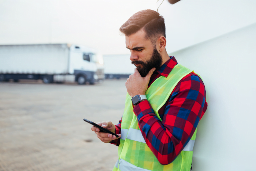 delivery driver thinking looking at phone