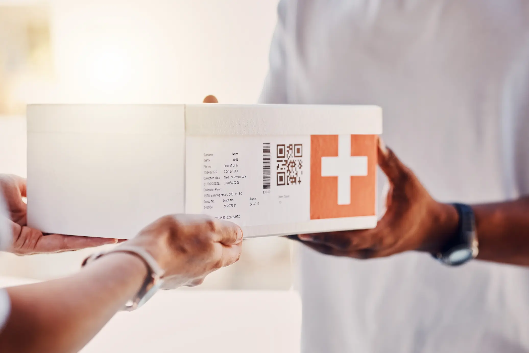 image of medical healthcare parcel being handed between 2 people